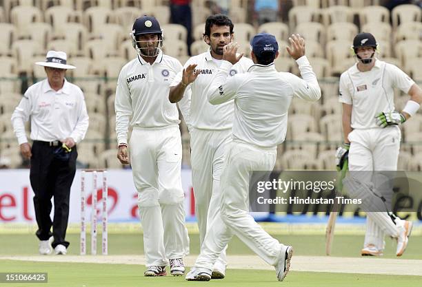 Indian pacer Zaheer Khan celebrates with teammates after taking the wicket of Bredon McCullum during the second Test match between India and New...