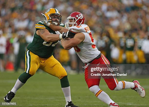 Andy Studebaker of the Kansas City Chiefs rushes against Don Barclay of the Green Bay Packers during a preseason game at Lambeau Field on August 30,...