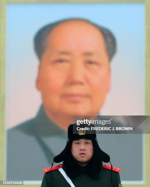 Chinese paramilitary guard mans his post in front of Tiananmen Rostrum beneath the iconic portrait of the late Chairman Mao Zedong following an...