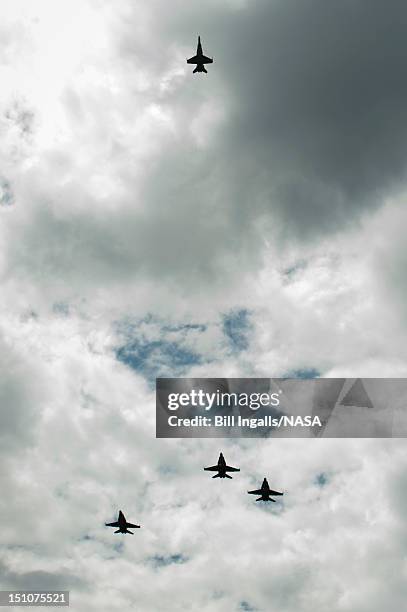 In this handout photo provided by NASA, U.S. Navy F/A-18 jets from Strike Fighter Squadron 106 and Strike Fighter Squadron 34, from Naval Air Station...