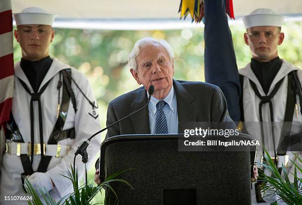 In this handout photo provided by NASA, businessman and friend of Neil Armstrong, Charles Mechem, speaks during a memorial service celebrating the...