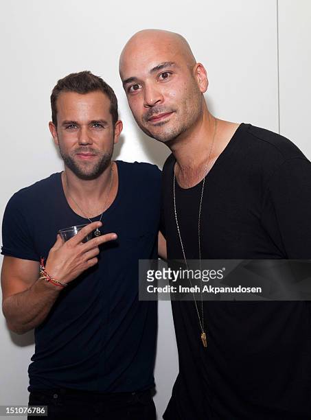 Anthony Gonzalez of M83 and designer Brandon Scott attend the grand opening of Android Homme's IX II II on August 30, 2012 in Los Angeles, California.