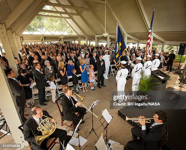 In this handout photo provided by NASA, members of the U.S. Navy Ceremonial Guard from Washington, DC present the Colors during a memorial service...