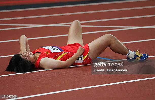 Ping Liu of China lies on the track after winning gold in the Women's 200m - T35 Final on day 2 of the London 2012 Paralympic Games at Olympic...