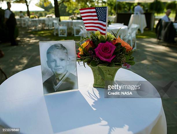 In this handout photo provided by NASA, a photograph of Neil Armstrong as a young man is displayed on a table during a memorial service celebrating...