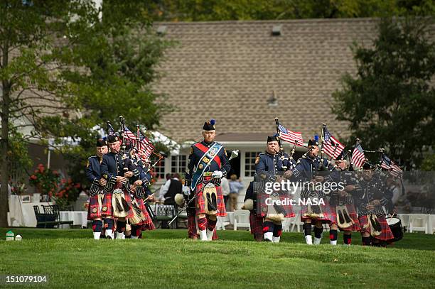 In this handout photo provided by NASA, the Hamilton Co. Sheriff's Office bagpipe corps concludes the memorial service celebrating the life of Neil...