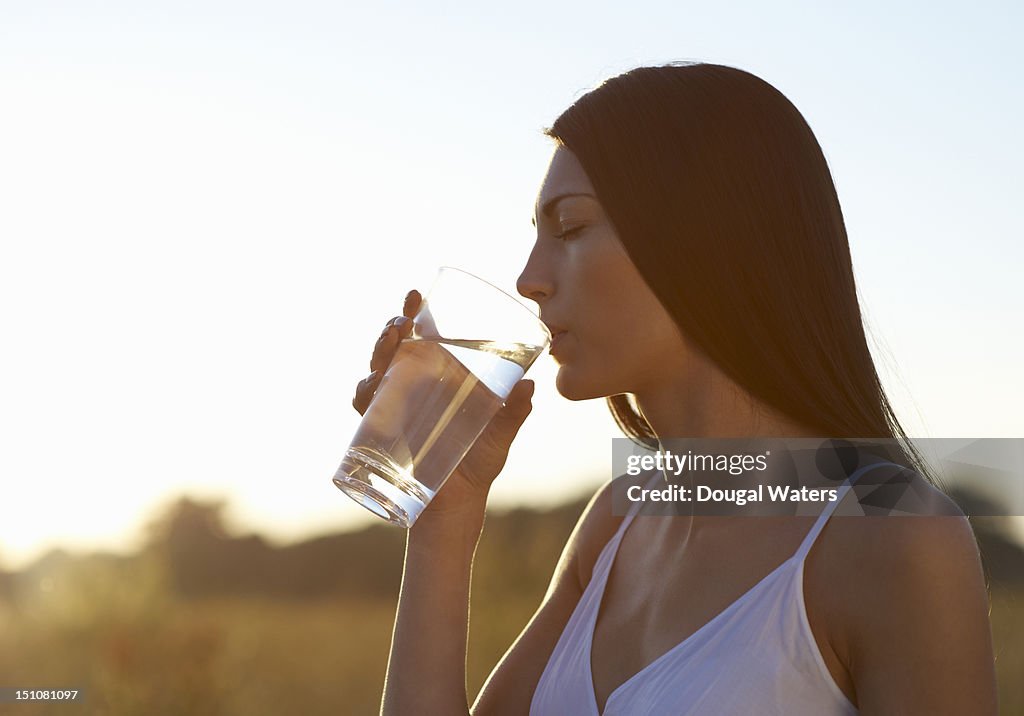 Profile of woman drinking water on hot Summers day