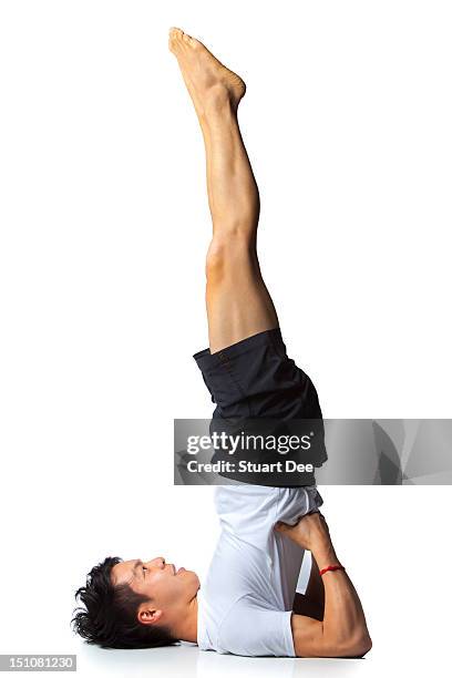 asian male in yoga pose - piernas en el aire fotografías e imágenes de stock