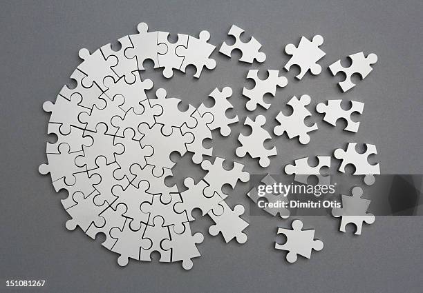 radiating silver metal puzzle, half assembled - onvolledig stockfoto's en -beelden