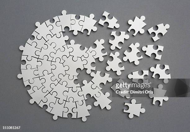 radiating silver metal puzzle, half assembled - chaos concept stock pictures, royalty-free photos & images