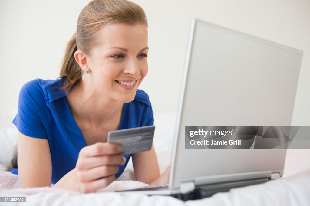 Woman on laptop with credit card