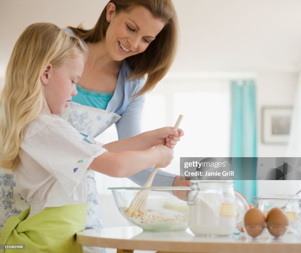 Mother and daughter baking together