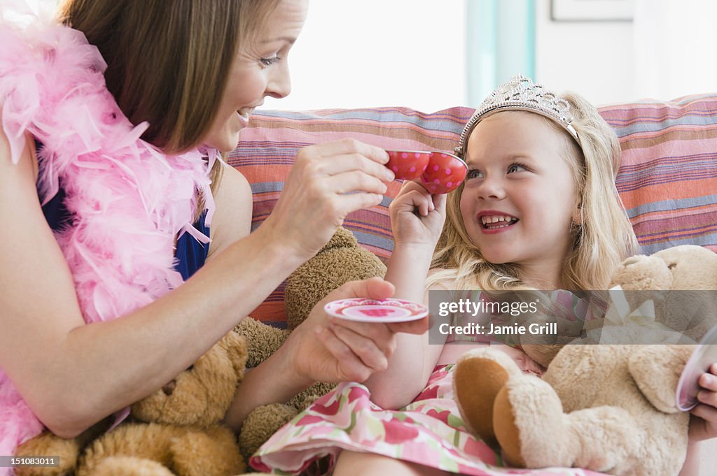 Mother and daughter playing dress up together