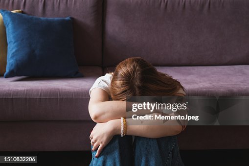 Upset depressed teenager girl covering face with hands and crying Upset depressed teenager girl covering face with hands and crying