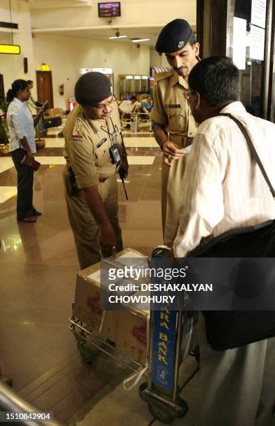 Indian paramilitary soldiers check passengers luggage and documents at the entrance to Netaji Subhash Chandra Bose International Airport in Kolkata,...
