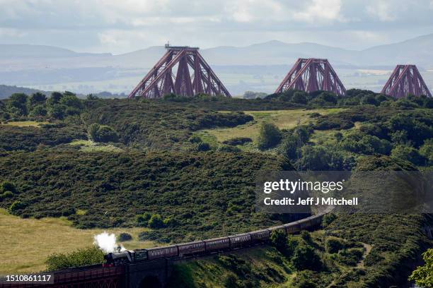 The Flying Scotsman locomotive crosses the Forth Bridge, as it makes a journey to Aberdeen during the steam train’s centenary tour on July 03, 2023...
