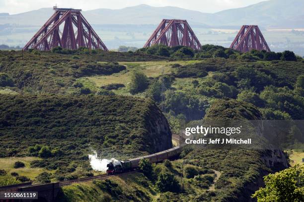 The Flying Scotsman locomotive crosses the Forth Bridge, as it makes a journey to Aberdeen during the steam train’s centenary tour on July 03, 2023...