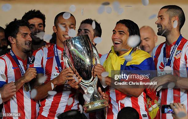 Falcao of Atletico Madrid celebrates with the UEFA Super Cup following the match between Chelsea and Atletico Madrid at Louis II Stadium on August...