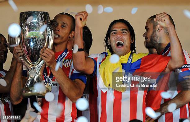 Falcao of Atletico Madrid celebrates as team-mate Miranda lifts the UEFA Super Cup following the match between Chelsea and Atletico Madrid at Louis...