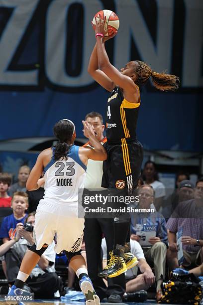 Amber Holt of the Tulsa Shock shoots the ball against Maya Moore of the Minnesota Lynx during the WNBA game on August 31, 2012 at Target Center in...