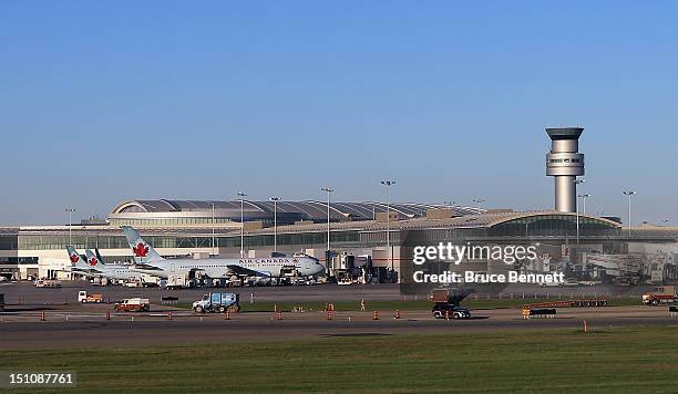 View of Air Canada jets and the control tower at the Lester B. Pearson airport as photographed from an airplane on August 28, 2012 in Toronto, Canada.