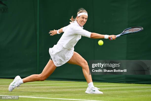 Victoria Azarenka plays a backhand against Yue Yuan of People's Republic of China in the Women's Singles first round match on day one of The...