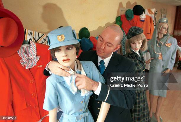 Royal Dutch Airlines flight attendant Cliff Muskiet dresses a mannequin while showing his collection of uniforms from over 70 different airlines...