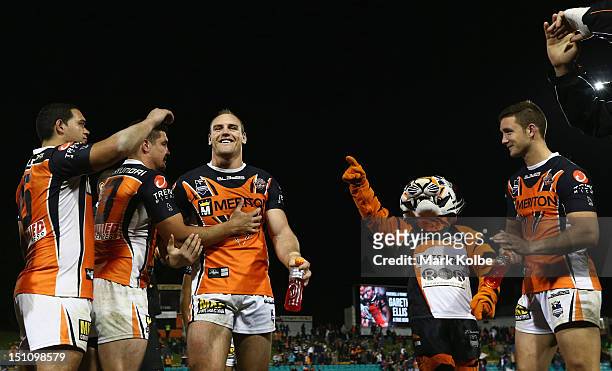 Gareth Ellis of the Tigers leaves the field through a guard of honour after his last match during the round 26 NRL match between the Wests Tigers and...