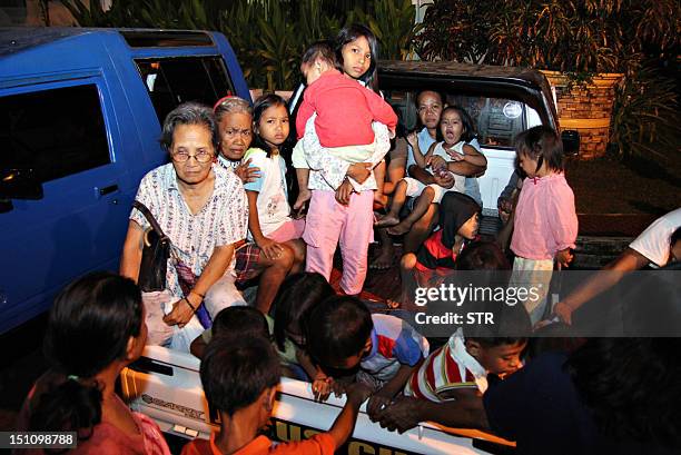 Residents arrive at the provincial capitol building in Tandag City, Surigao Del Sur Province, in the southern island of Mindanao on August 31 after a...