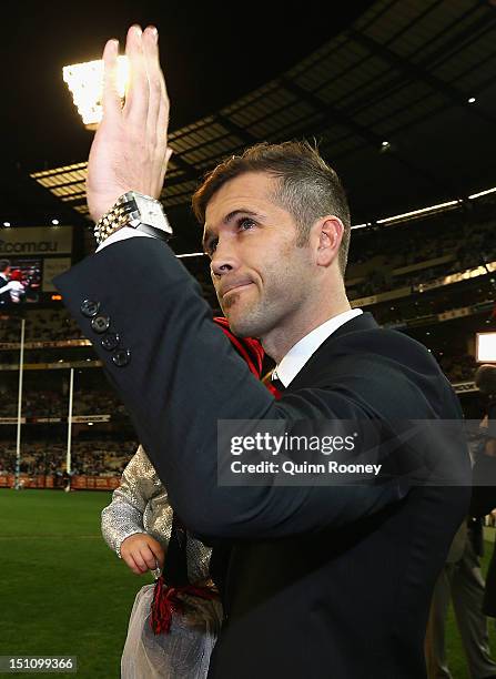 Mark McVeigh of the Bombers leads the team out onto the field during the round 23 AFL match between the Essendon Bombers and the Collingwood Magpies...