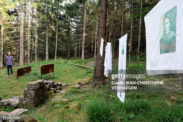 Man looks at an artwork entitled "Leached Memory" by artist David Dujardin and displayed around the Smugglers Path as part of the Contemporary Art...