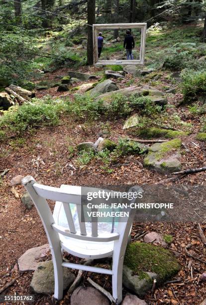 People are seen through an artwork entitled "Modest pastoral installation" by artist Marie-Haude Steyer, which is displayed around the Smugglers Path...