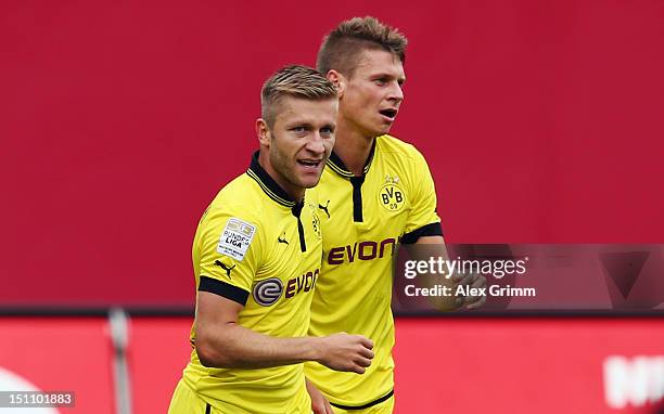 Jakub Blaszczykowski of Dortmund celebrates his team's first goal with team mate Lukasz Piszczek during the Bundesliga match between 1. FC Nuernberg...