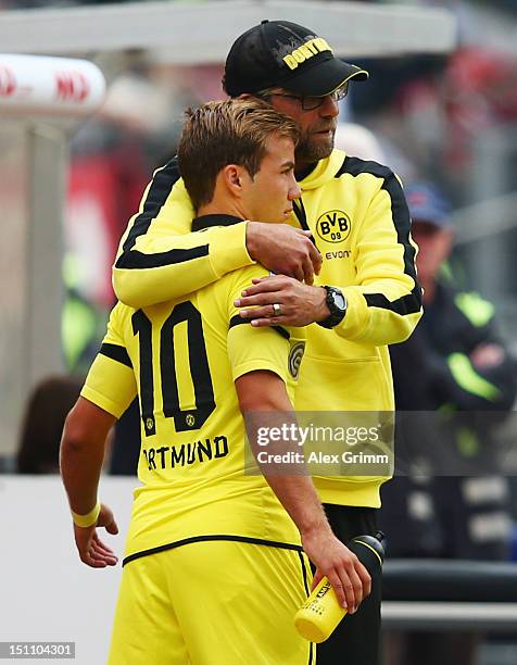 Head coach Juergen Klopp of Dortmund hugs Mario Goetze during the Bundesliga match between 1. FC Nuernberg and Borussia Dortmund at Easy Credit...