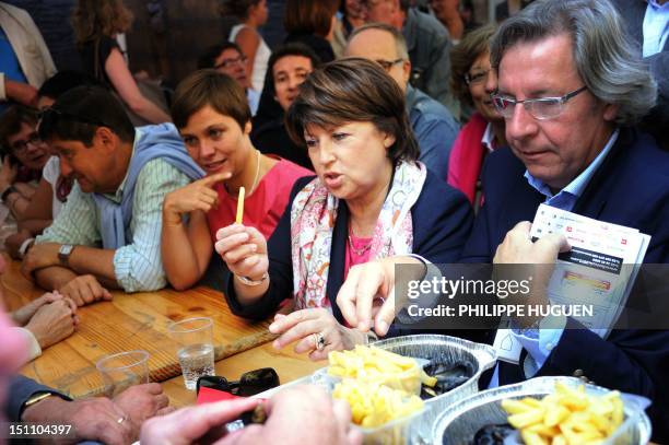 French socialist party first secretary Martine Aubry eats French fries as she visits Lille's braderie on September 1, 2012 in Lille, northern France....