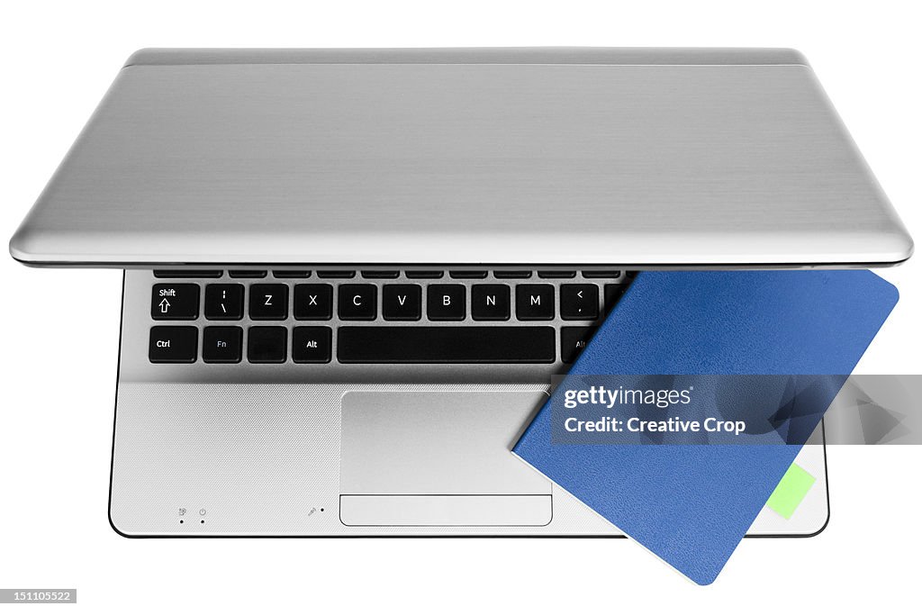 An open laptop computer with a notebook