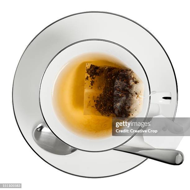 overhead of a cup of tea with tea bag - tea cup overhead view photos et images de collection