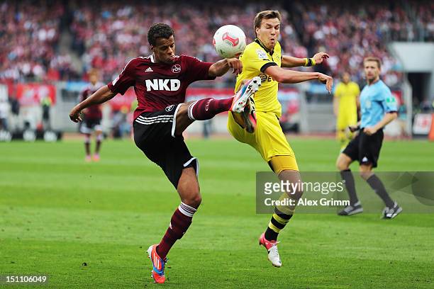 Timothy Chandler of Nuernberg is challenged by Kevin Grosskreutz of Dortmund during the Bundesliga match between 1. FC Nuernberg and Borussia...