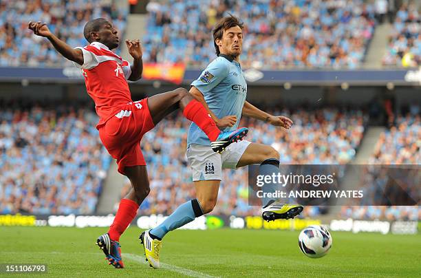 Manchester City's Spanish midfielder David Silva vies with Queens Park Rangers' English midfielder Shaun Wright-Phillips during the English Premier...