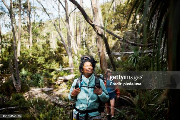 woman exploring the rugged beauty of tasmania's wilderness on a thrilling bushwalking adventure. - wilderness stock pictures, royalty-free photos & images