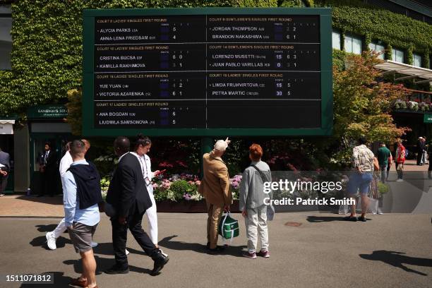 Spectators watch the scoreboard inside the premises during day one of The Championships Wimbledon 2023 at All England Lawn Tennis and Croquet Club on...