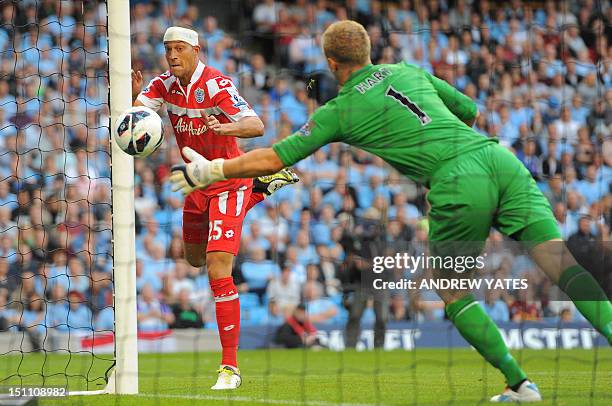 Queens Park Rangers' English striker Bobby Zamora scores past Manchester City's English goalkeeper Joe Hart during the English Premier League...