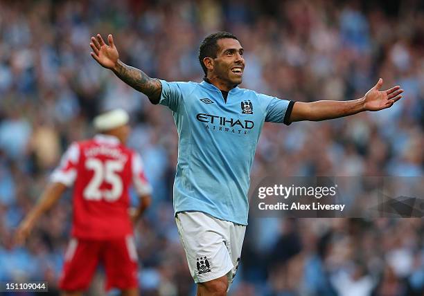 Carlos Tevez of Manchester City celebrates after scoring his goal during the Barclays Premier League match between Manchester City and Queens Park...