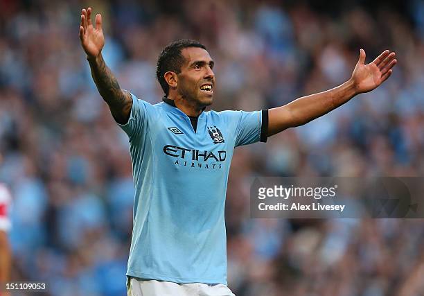 Carlos Tevez of Manchester City celebrates after scoring his goal during the Barclays Premier League match between Manchester City and Queens Park...