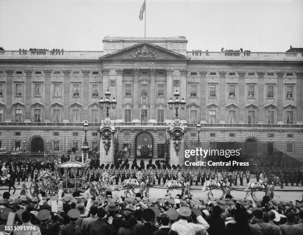 The Gold State Coach, carrying British Royals George VI and Queen Elizabeth, during the coronation procession, passes in front of Buckingham Palace,...