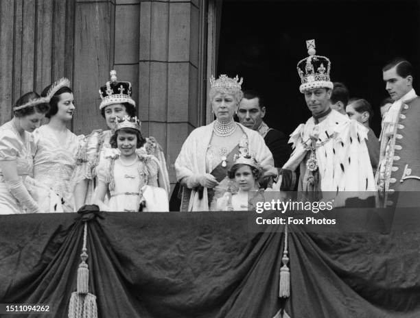 British Royals Queen Elizabeth, partially obscured behind her daughter, Princess Elizabeth, Mary of Teck, Princess Margaret, and George VI, on the...