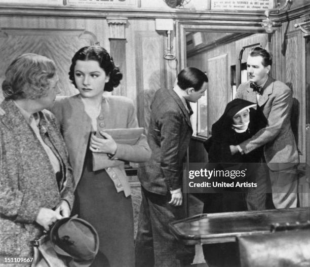 From left to right, Dame May Whitty, Margaret Lockwood, Naunton Wayne, Catherine Lacey in a nun costume and Michael Redgrave in a scene from the film...