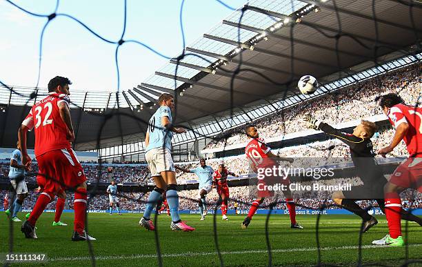 Yaya Toure of Manchester City scores the first goal during the Barclays Premier League match between Manchester City and Queens Park Rangers at...