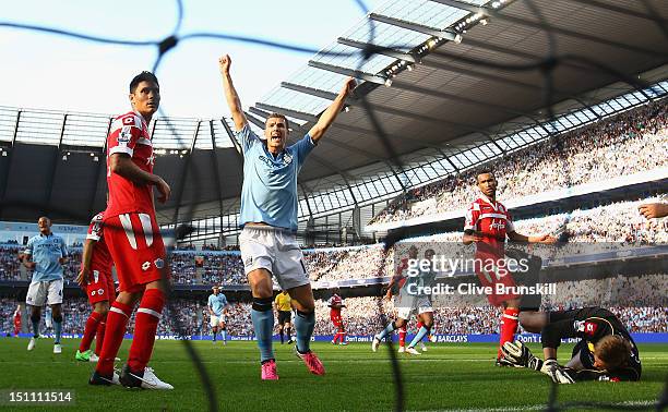 Yaya Toure of Manchester City scores the first goal during the Barclays Premier League match between Manchester City and Queens Park Rangers at...