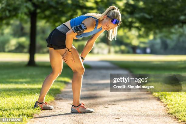 a female runner suffered a severe hamstring cramp after insufficient warm-up before running. - muscle cramps stock pictures, royalty-free photos & images